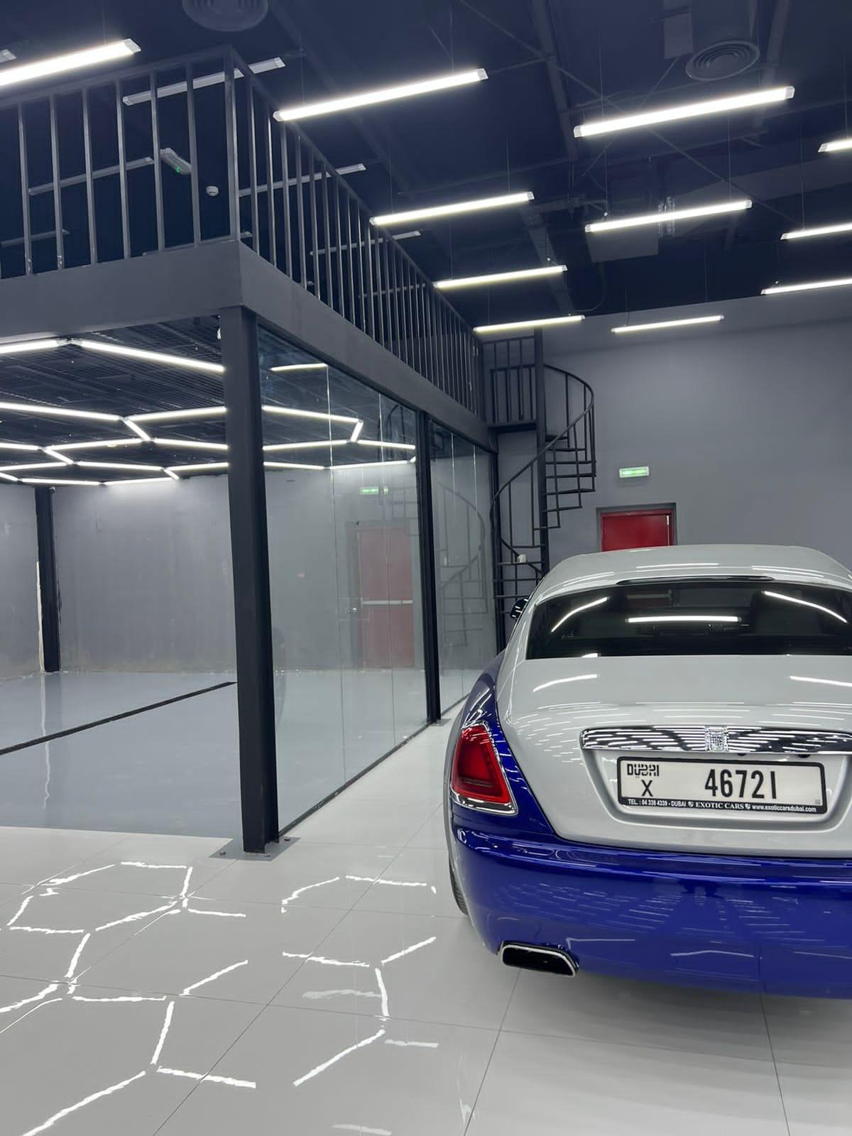 blue and silver luxury car park in showroom with black interior in Dubai