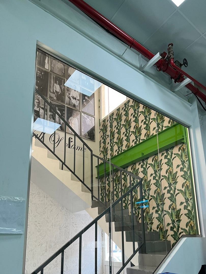 Stairs of an office with green design in a wall