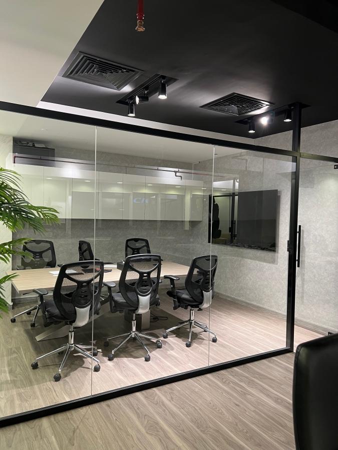 Small partition of an office with black chairs and office table