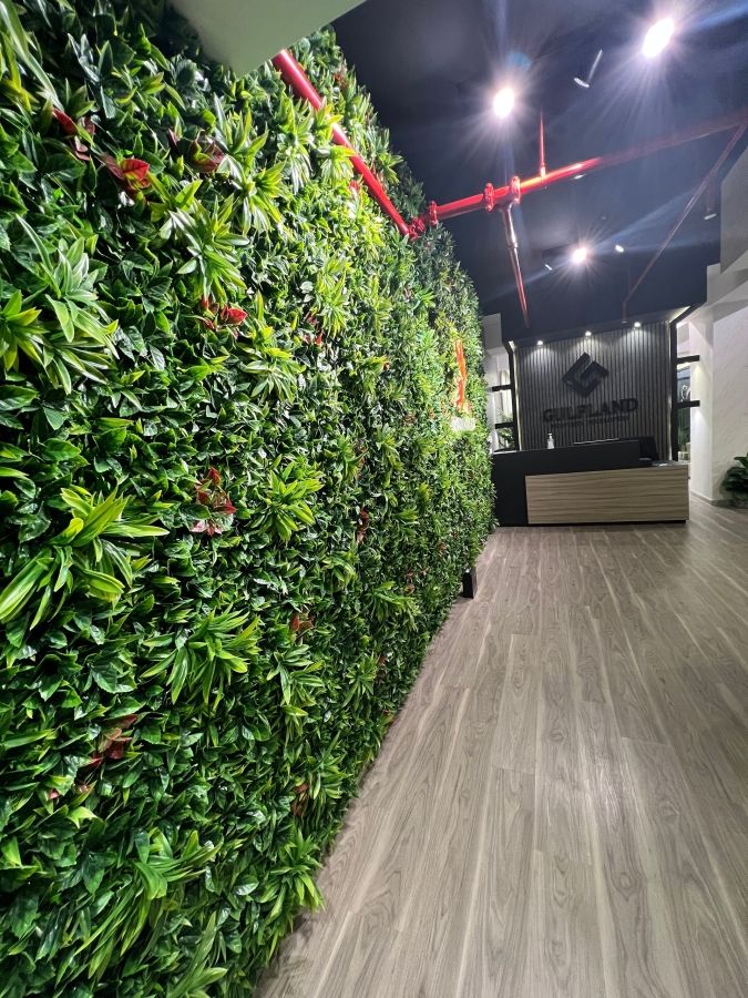 office wall decorated with artificial green leaves
