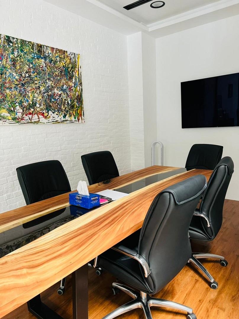 Office meeting room with black chairs and brown table